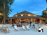 Guests dining at Pi Samui Beach Club at dusk